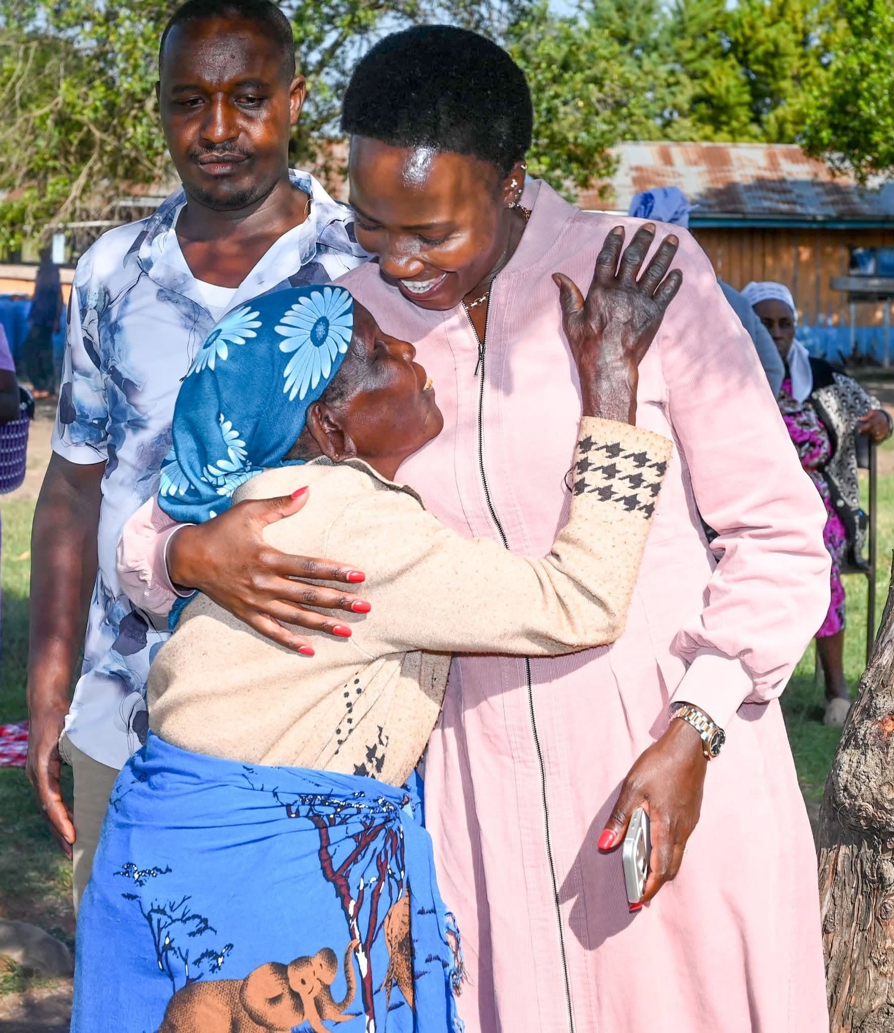 Chepkirui Kones embracing an elder in the community